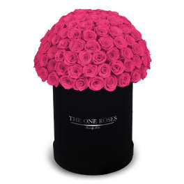 Hot pink roses arranged in a black round box