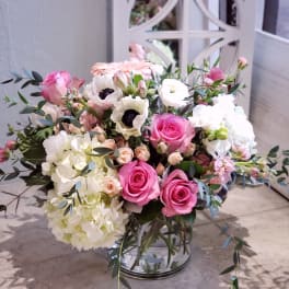 Pink and white mixed flower bouquet in a clear glass vase