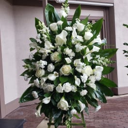 Large white floral standing spray on an easel