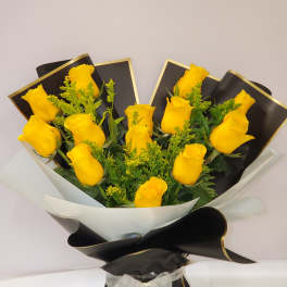 Bouquet of yellow roses wrapped in black and white paper