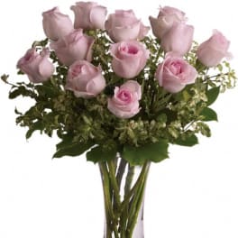 Pink roses arranged in a clear glass vase