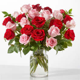 Bouquet of red and pink roses in a clear glass vase