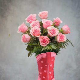 Pink roses arranged in a pink cowboy boot vase
