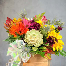 Mixed bouquet with sunflowers, gerbera daisies, and succulents in a wooden box