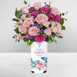 Pink and purple mixed bouquet in a tall white butterfly vase with 'happy mother's day' text