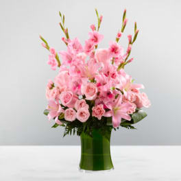 Pink flowers arranged in a green glass vase