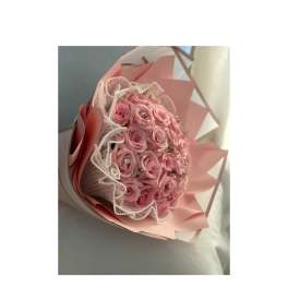 Pink rose bouquet wrapped in pastel paper with lace trim