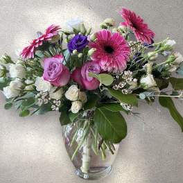 Pink and white mixed bouquet in a clear glass vase
