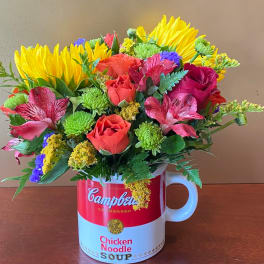 Mixed bouquet in a Campbell's soup mug vase