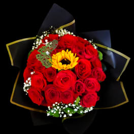 Bouquet of red roses with a yellow sunflower center