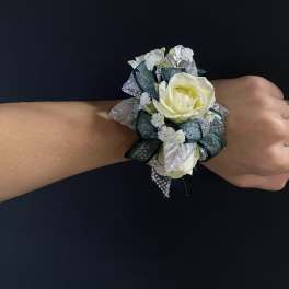 White rose wrist corsage with silver and dark green ribbon