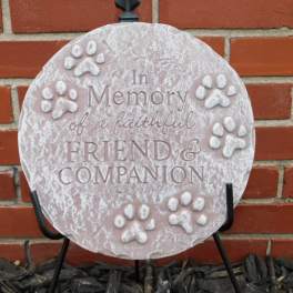 Round memorial plaque with paw prints and the words In Memory of a faithful Friend & Companion