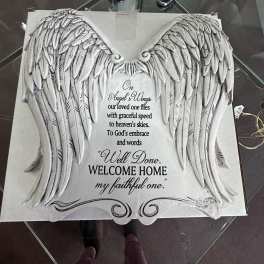 Decorative angel wings plaque with a memorial quote