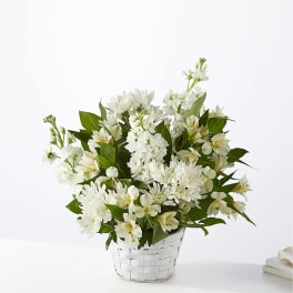 White flowers arranged in a white woven basket