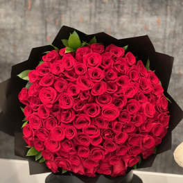 Large bouquet of red roses wrapped in black paper