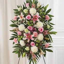 Standing floral spray with pink lilies, roses, and white blooms