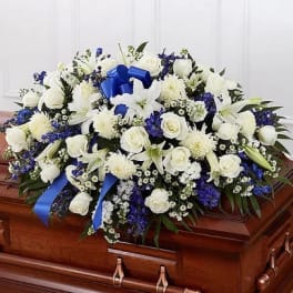 White and blue funeral spray on a casket
