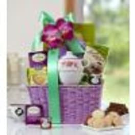 Gift basket with flowers, chocolates, and a teddy bear