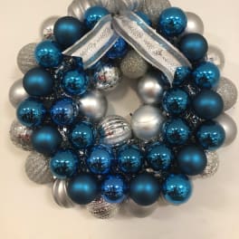 Blue and silver ornament wreath with a ribbon bow