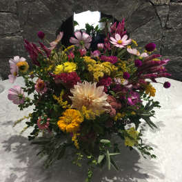 Mixed bouquet with pink, yellow, and cream flowers on a table