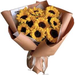 Bouquet of yellow sunflowers wrapped in brown paper