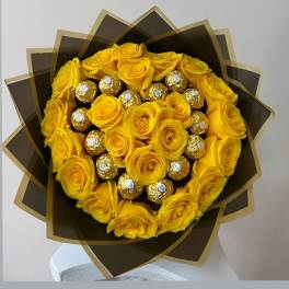 Bouquet of yellow roses with gold-wrapped chocolates