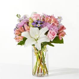 Pink and white mixed bouquet in a clear glass vase