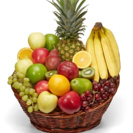 Fruit basket with pineapple, bananas, apples, grapes, oranges, pears, and kiwi