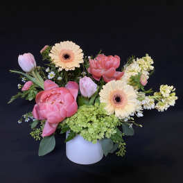 Pink and cream mixed bouquet in a white vase