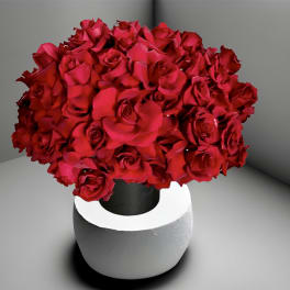 Red rose bouquet in a white and black vase