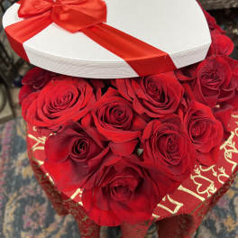 Heart-shaped box of red roses with a red ribbon and bow