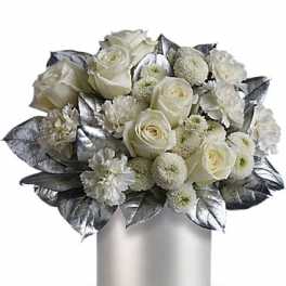 White rose bouquet in a silver vase with metallic leaves
