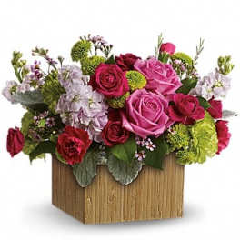 Mixed bouquet of pink and red roses in a wooden box