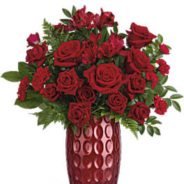 Red roses arranged in a tall red vase