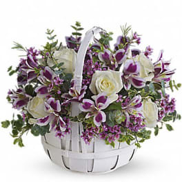 White basket of purple orchids and white roses