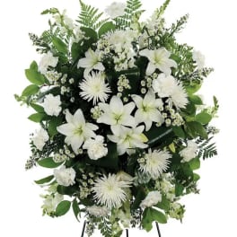A classic white floral sympathy standing spray