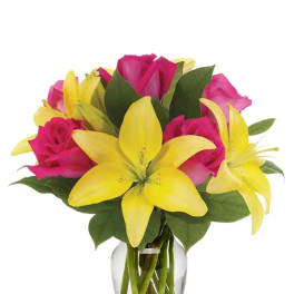 Bouquet of pink roses and yellow lilies in a clear glass vase