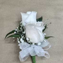 White rose boutonniere with baby's breath, crystal accents, and a sheer white bow.