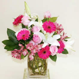 Pink and white mixed bouquet in a clear glass vase