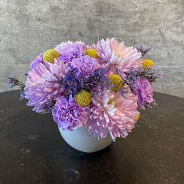 Pink and lavender bouquet in a white vase