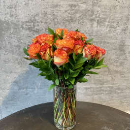 Orange roses in a clear glass vase