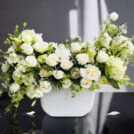 White roses and green-white flowers in a white textured vase