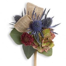 Small boutonniere with blue thistle and burgundy blooms wrapped in twine