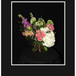 Bouquet of pink, white, and purple flowers against a black background