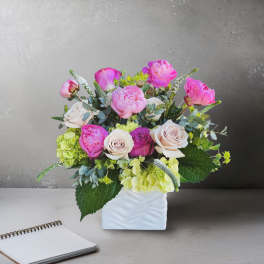 Pink and cream bouquet in a white vase