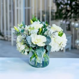White floral arrangement in a clear glass vase