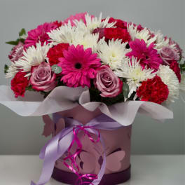 Pink and white mixed bouquet in a decorated box with ribbon