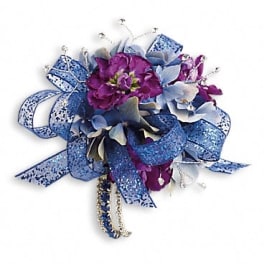 Purple and blue floral corsage with glittery ribbon