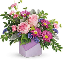 Pink roses and purple daisies in a lavender box vase