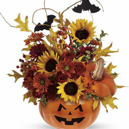 Halloween pumpkin container with sunflowers, mums, roses, and bat decorations